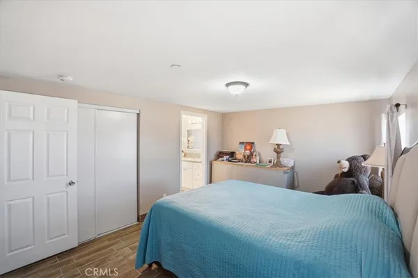 a bedroom with a bed and a closet
