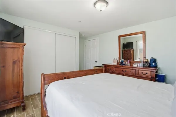 a bed room with a bed and a large mirror