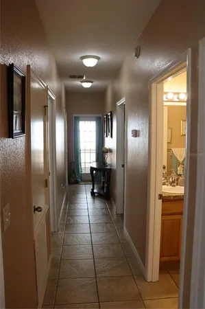 a view of a hallway with wooden shelves