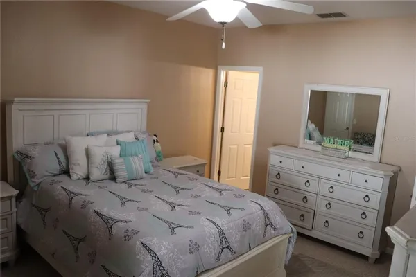 a bedroom with a bed and a dresser