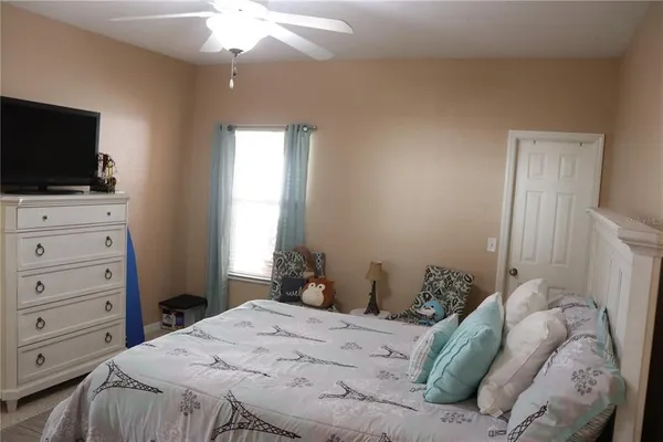 a bedroom with a bed and a flat screen tv