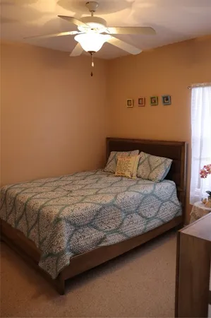 a bedroom with a bed and window