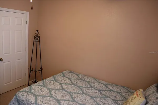 a bedroom with a bed and a closet