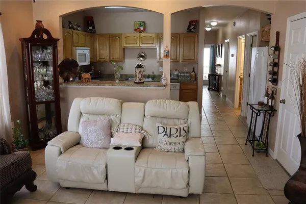 a living room with furniture and a chandelier