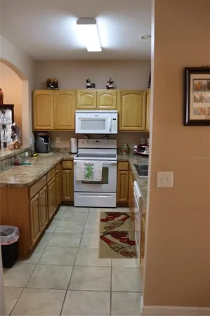 a kitchen with a stove sink and cabinets