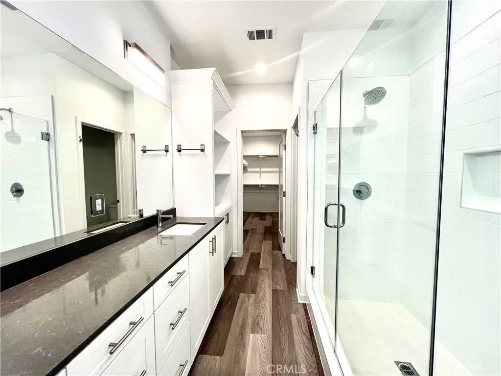 2336 Synergy Irvine, CA 92614 - Photo 14 of 24 a spacious bathroom with a granite countertop sink a mirror a shower and a bathtub