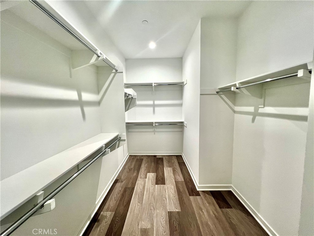 2336 Synergy Irvine, CA 92614 - Photo 16 of 24 a view of a walk in closet with wooden floor