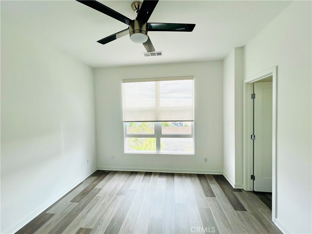2336 Synergy Irvine, CA 92614 - Photo 18 of 24 a view of an empty room with wooden floor and a window