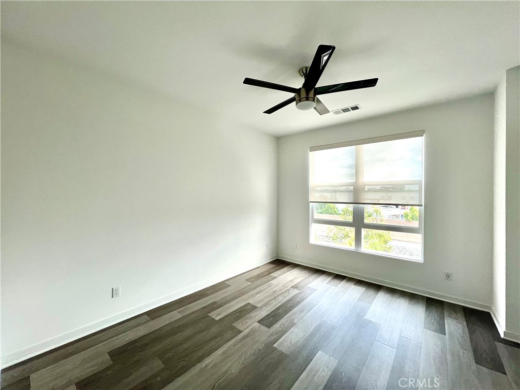 2336 Synergy Irvine, CA 92614 - Photo 9 of 24 an empty room with wooden floor and windows