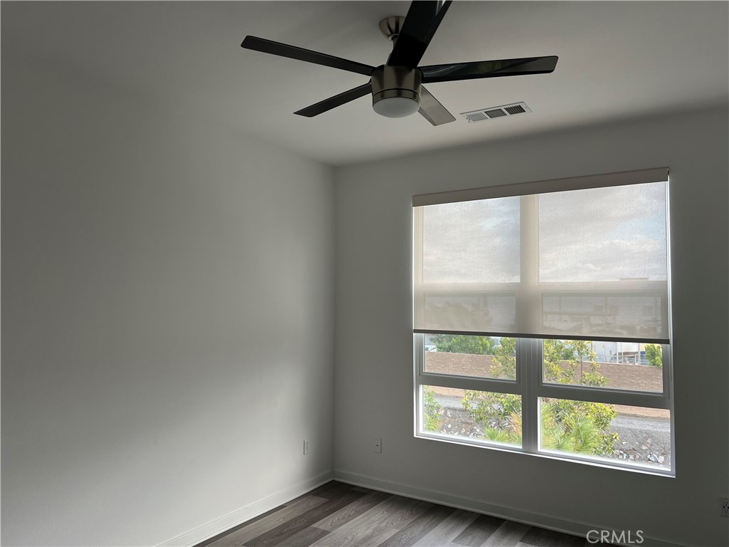 2336 Synergy Irvine, CA 92614 - Photo 10 of 24 an empty room with wooden floor and windows