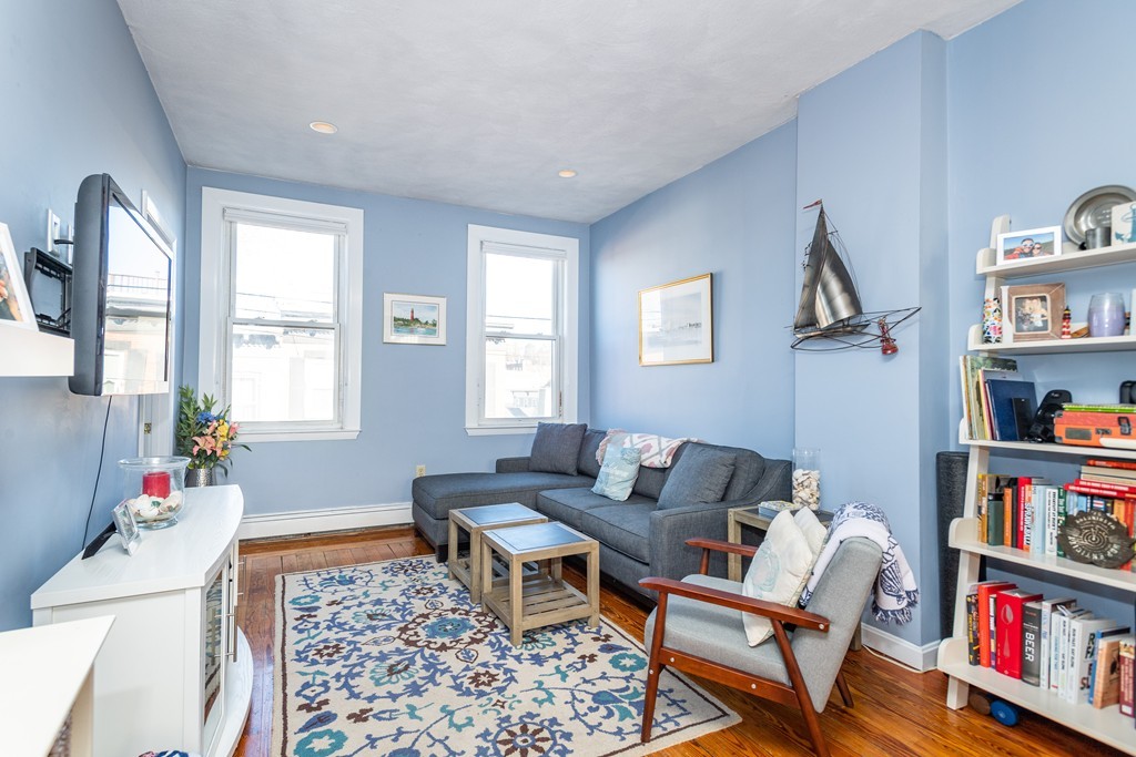 23-23A Sullivan Street, Unit 3 Boston, MA 02129 - Photo 1 of 8 a living room with furniture and a book shelf