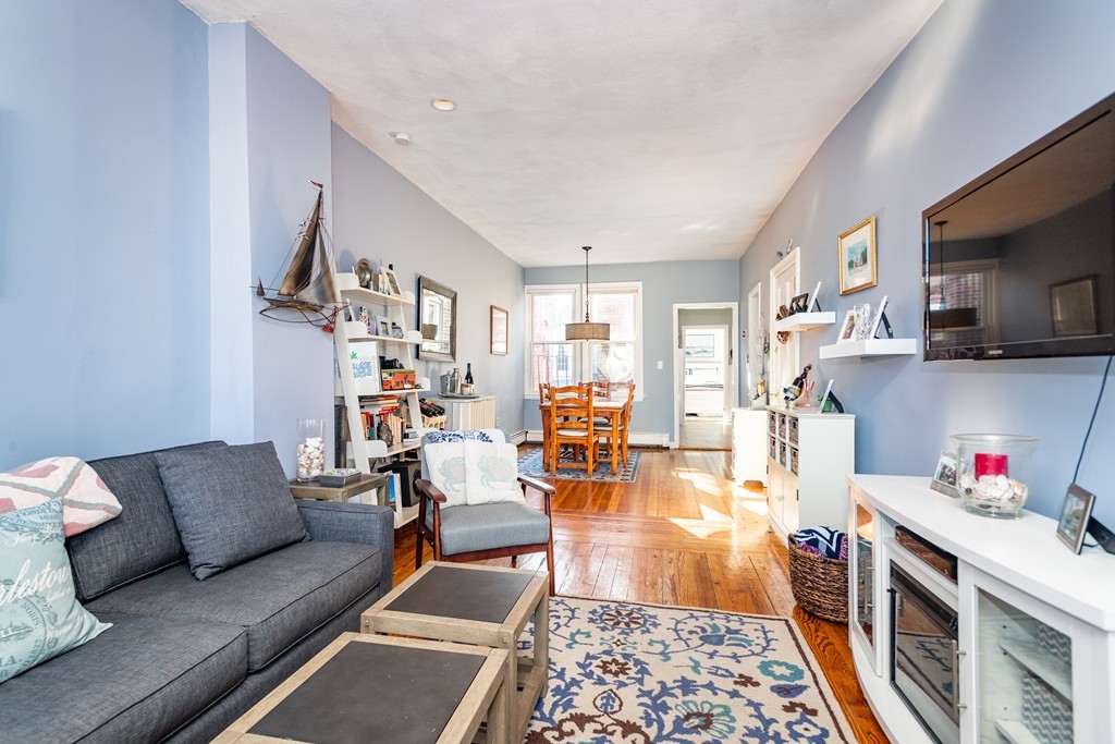 23-23A Sullivan Street, Unit 3 Boston, MA 02129 - Photo 2 of 8 a living room with furniture and a wooden floor