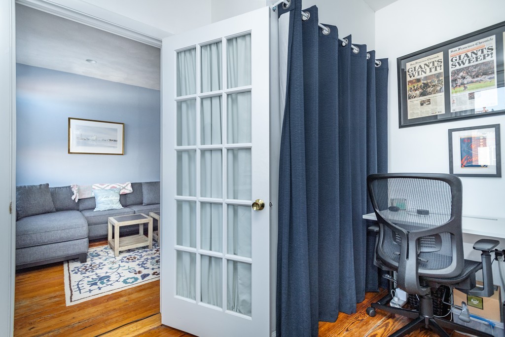 23-23A Sullivan Street, Unit 3 Boston, MA 02129 - Photo 6 of 8 a living room with furniture a rug and a window