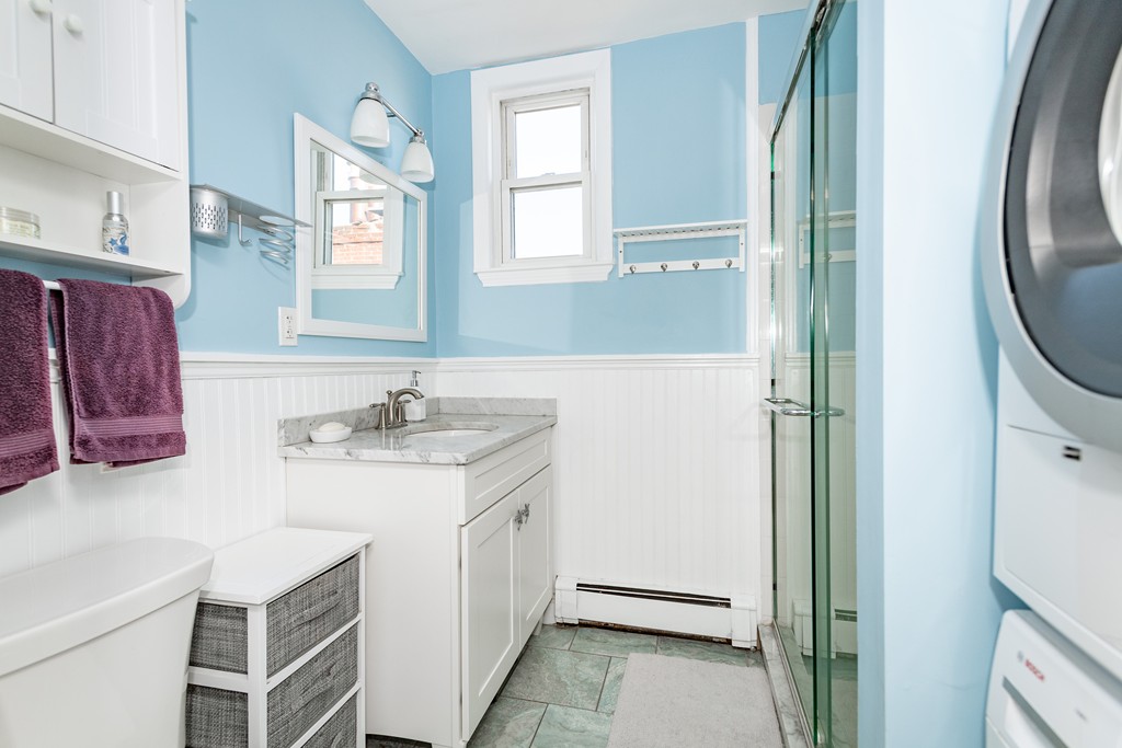 23-23A Sullivan Street, Unit 3 Boston, MA 02129 - Photo 7 of 8 a bathroom with a sink a mirror and a shower