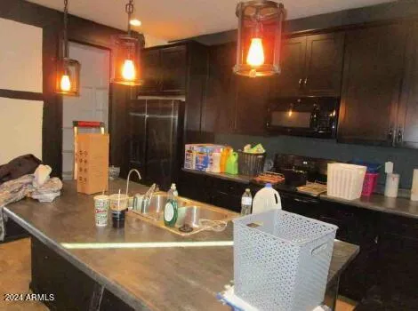 a kitchen with a sink a counter and chairs