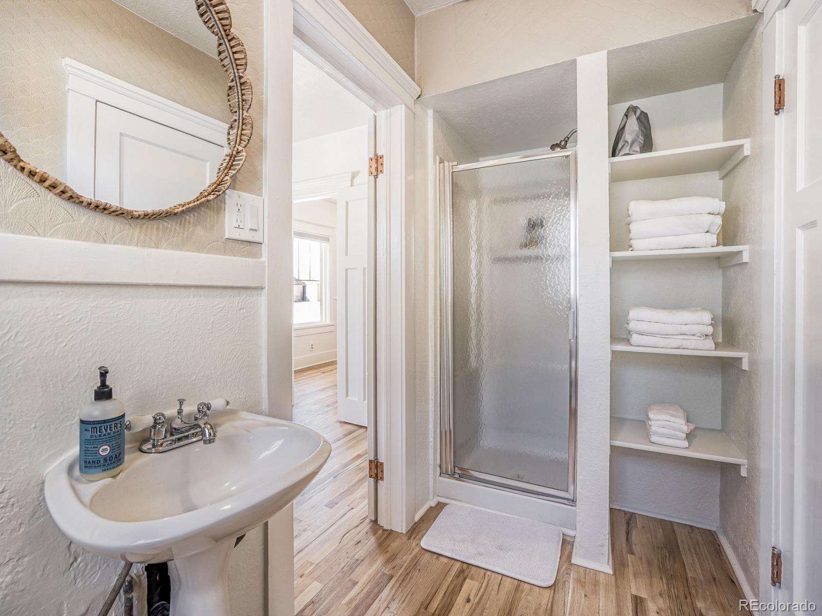 7607 Ralston Road Arvada, CO 80002 - Photo 15 of 28 a bathroom with a sink a toilet and shower