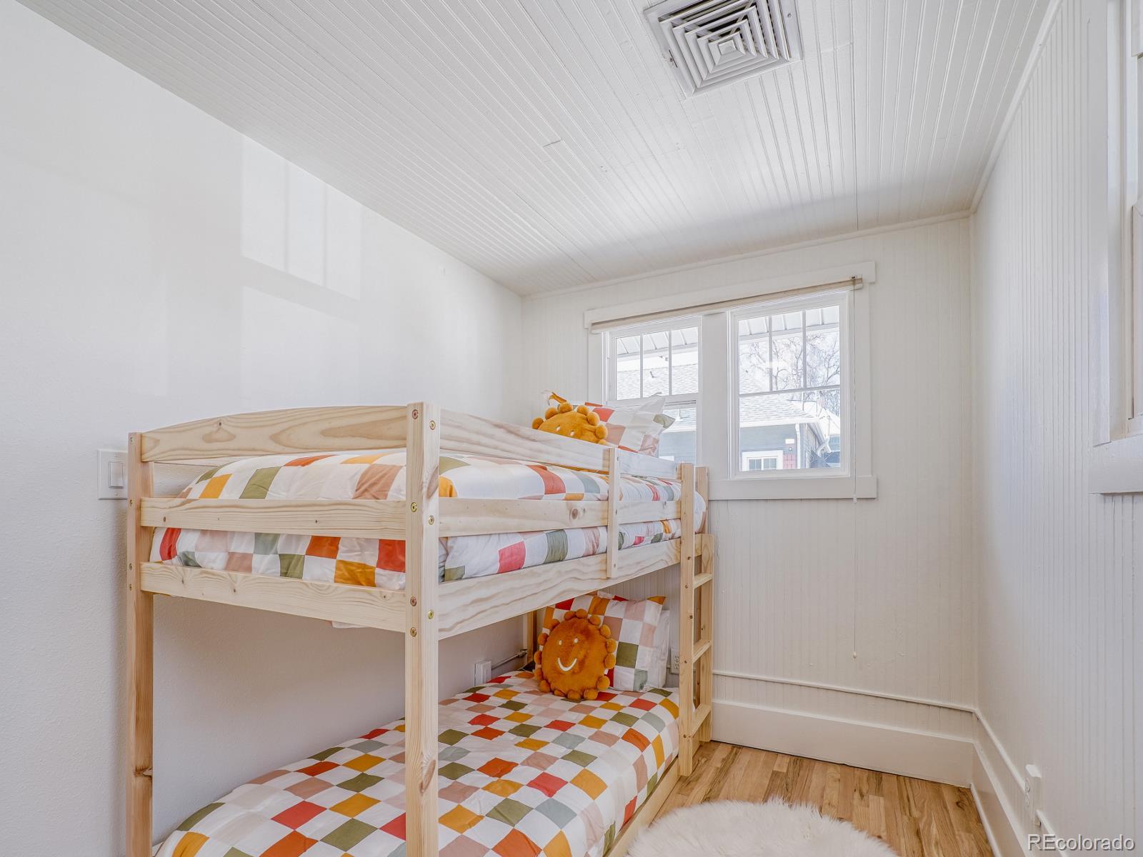 7607 Ralston Road Arvada, CO 80002 - Photo 17 of 28 a bedroom with baby crib and hanging window