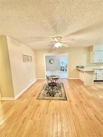 a living room with furniture and view of kitchen