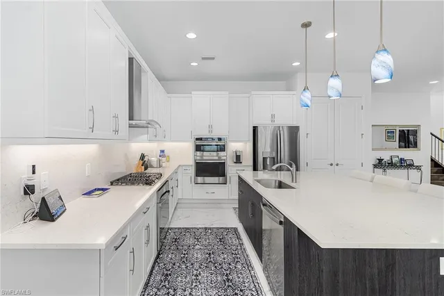 a kitchen with a sink stove and refrigerator