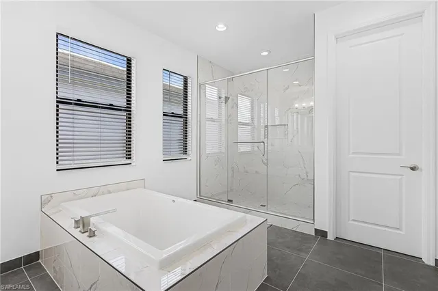 a bathroom with a granite countertop sink and a toilet