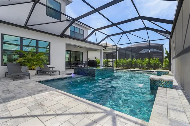 a view of a house with backyard and sitting area
