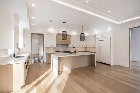 a kitchen with stainless steel appliances granite countertop a sink and window