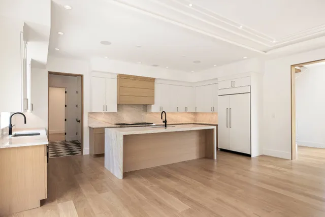 a kitchen with stainless steel appliances granite countertop a sink stove and cabinets