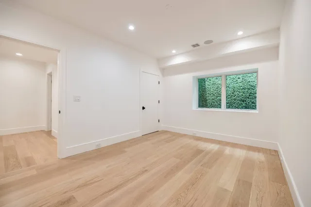 a view of a kitchen with a sink and a refrigerator