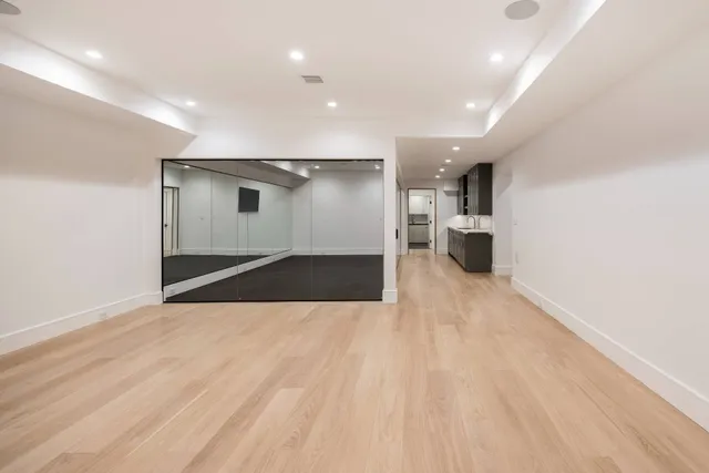 a view of empty room with wooden floor