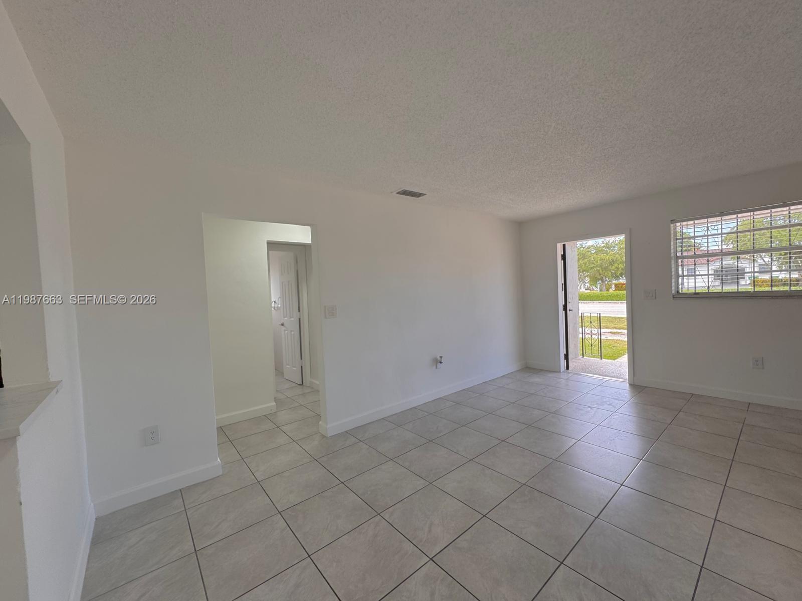 3630 Southwest 87th Avenue Miami, FL 33165 - Photo 4 of 14 a view of an empty room and window