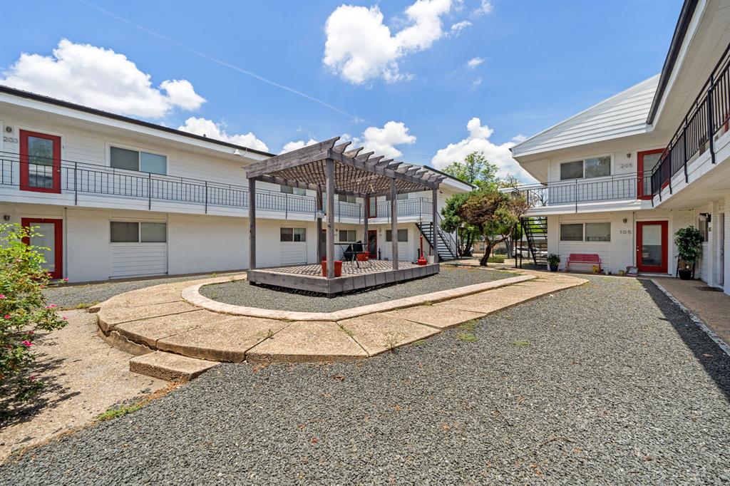 1313 East 52nd Street, Unit 105 Austin, TX 78723 - Photo 16 of 16 a view of a building with a yard