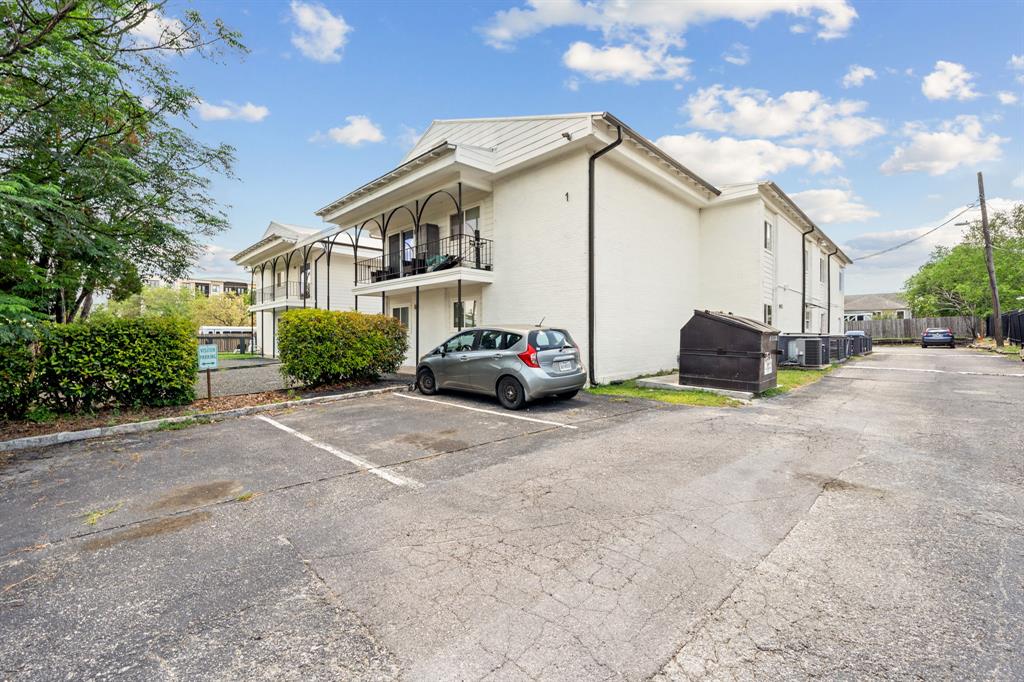 1313 East 52nd Street, Unit 105 Austin, TX 78723 - Photo 2 of 16 a car parked in front of white house