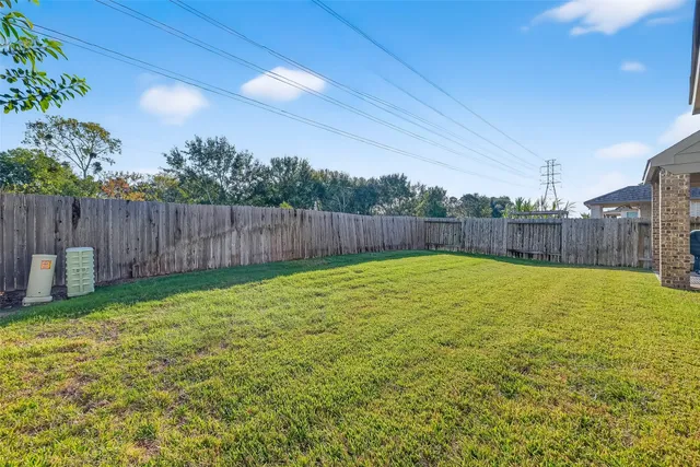 a view of a backyard with a fence