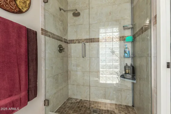 a bathroom with a sink a large mirror and a bathtub