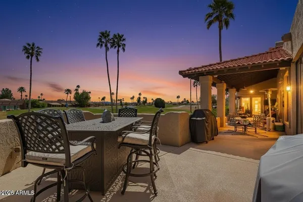 a view of chairs and table in the patio