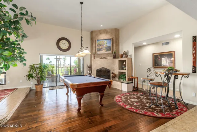 a living room with lots of furniture and a ceiling fan