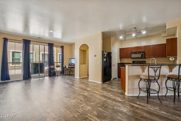 a view of a kitchen with furniture and wooden floor