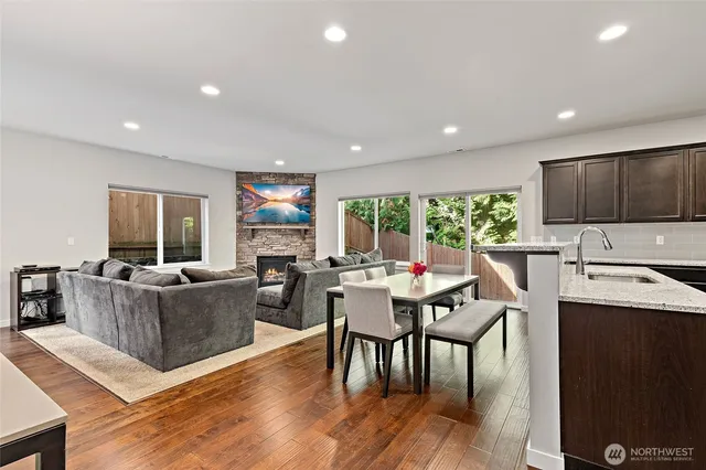 a living room with furniture a wooden floor and a window