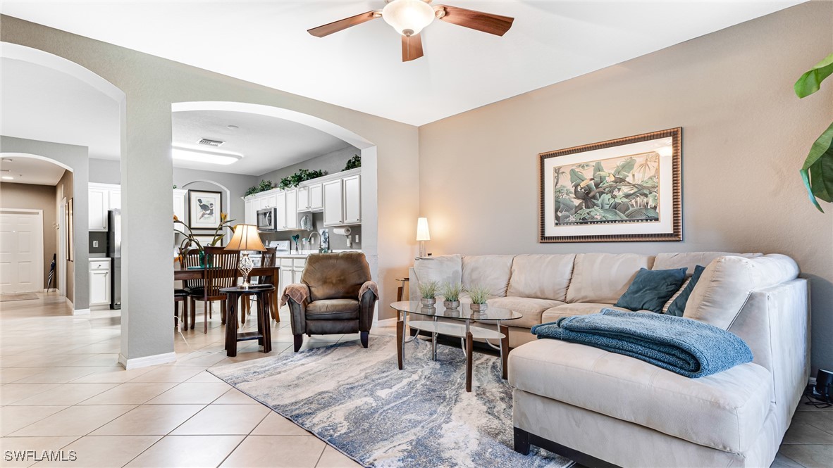 14801 Reflection Key Circle, Unit 212 Fort Myers, FL 33907 - Photo 13 of 33 a living room with furniture and a dining table