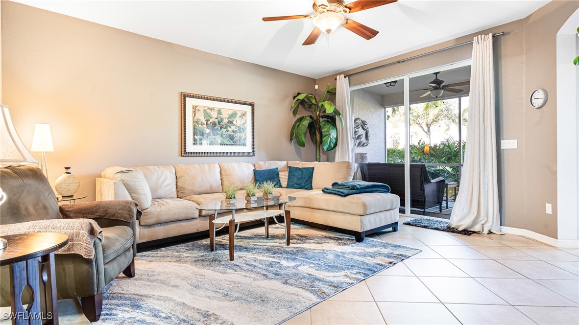 14801 Reflection Key Circle, Unit 212 Fort Myers, FL 33907 - Photo 14 of 33 a living room with furniture and a large window