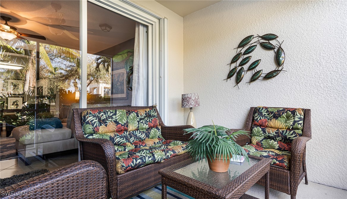 14801 Reflection Key Circle, Unit 212 Fort Myers, FL 33907 - Photo 17 of 33 a living room with furniture and flowers