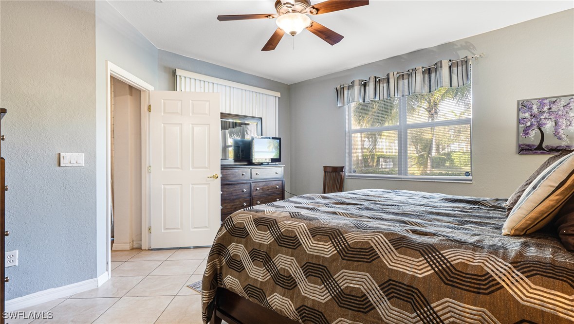14801 Reflection Key Circle, Unit 212 Fort Myers, FL 33907 - Photo 20 of 33 a bedroom with a bed and a window