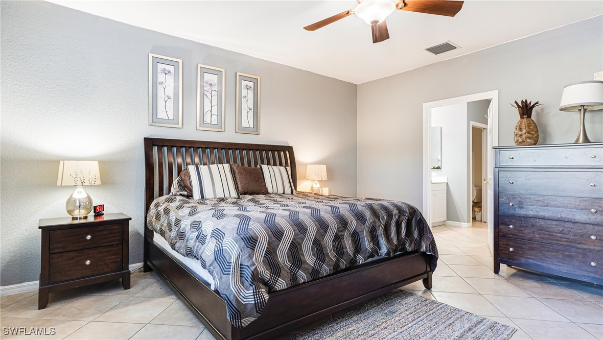 14801 Reflection Key Circle, Unit 212 Fort Myers, FL 33907 - Photo 21 of 33 a bedroom with a bed and a window