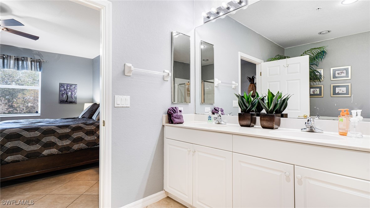 14801 Reflection Key Circle, Unit 212 Fort Myers, FL 33907 - Photo 22 of 33 a bathroom with a sink and a mirror