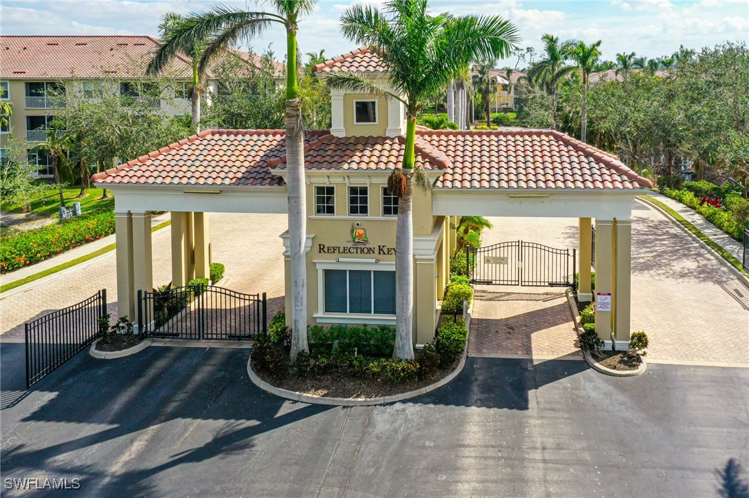 14801 Reflection Key Circle, Unit 212 Fort Myers, FL 33907 - Photo 24 of 33 a front view of a house with garden