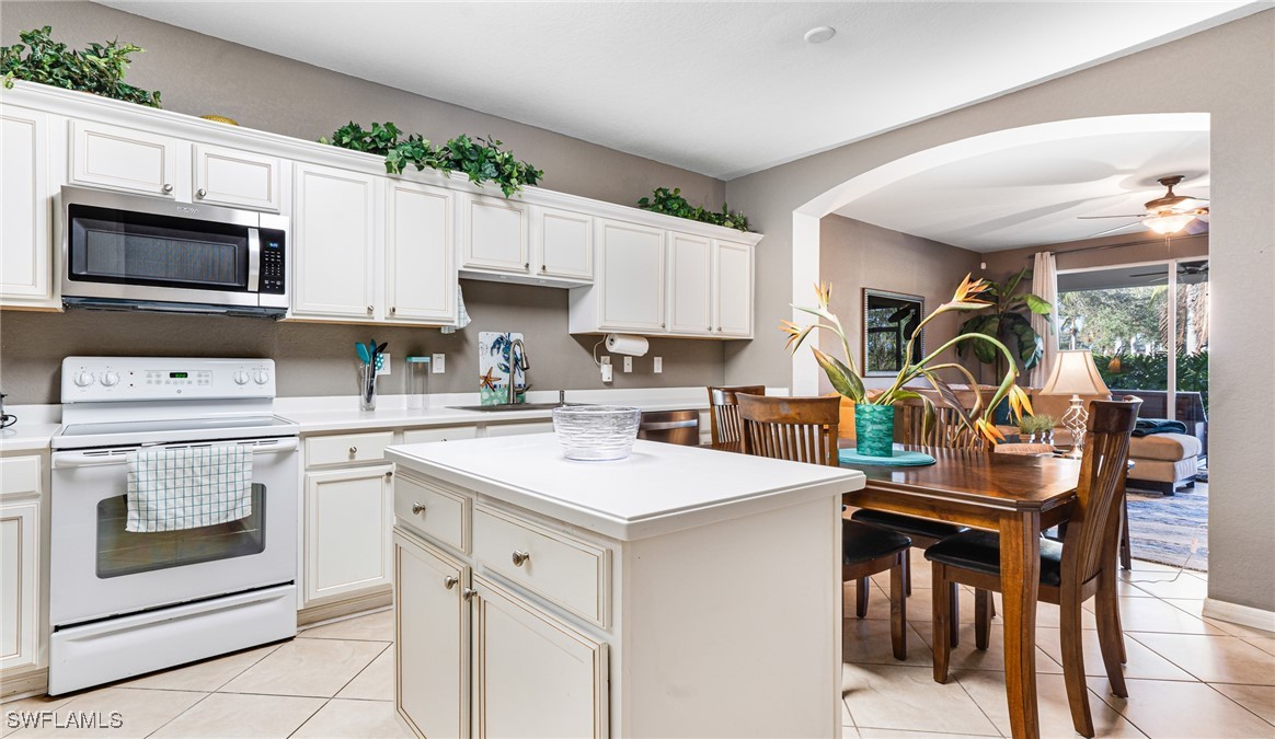 14801 Reflection Key Circle, Unit 212 Fort Myers, FL 33907 - Photo 10 of 33 a kitchen with a sink stove and white cabinets