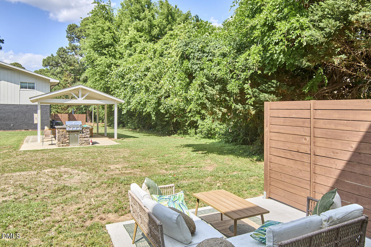 2613 McNeil Street, Unit E Raleigh, NC 27608 - Photo 26 of 28 a view of a patio with chairs and a yard