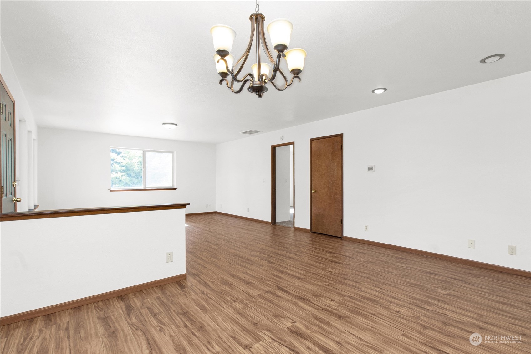 16635 Case Road Southwest Rochester, WA 98579 - Photo 11 of 35 a view of a room with wooden floor and chandelier
