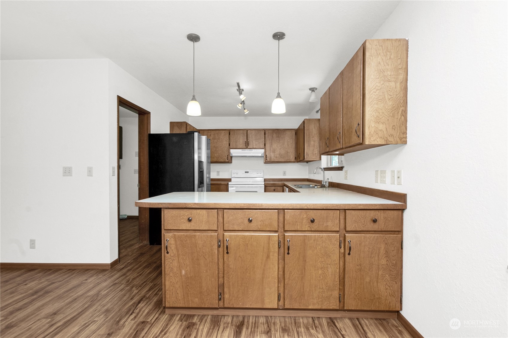 16635 Case Road Southwest Rochester, WA 98579 - Photo 13 of 35 a view of a kitchen with cabinets and wooden floor
