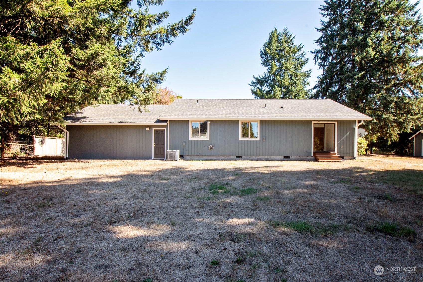16635 Case Road Southwest Rochester, WA 98579 - Photo 29 of 35 a view of a white house with a yard and large tree